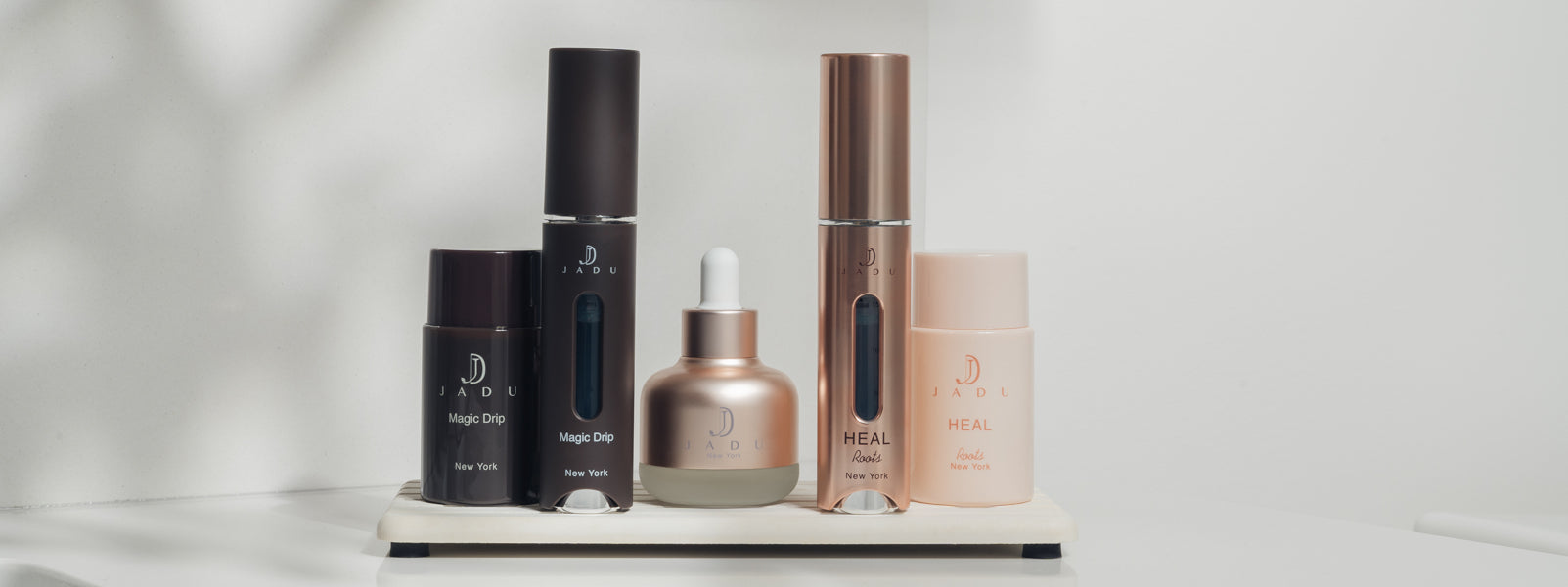 The full Jadu Beauty product line: Magic Drip, Jadu Split Ends Care, and Jadu Heal products shown together as the ultimate haircare routine.