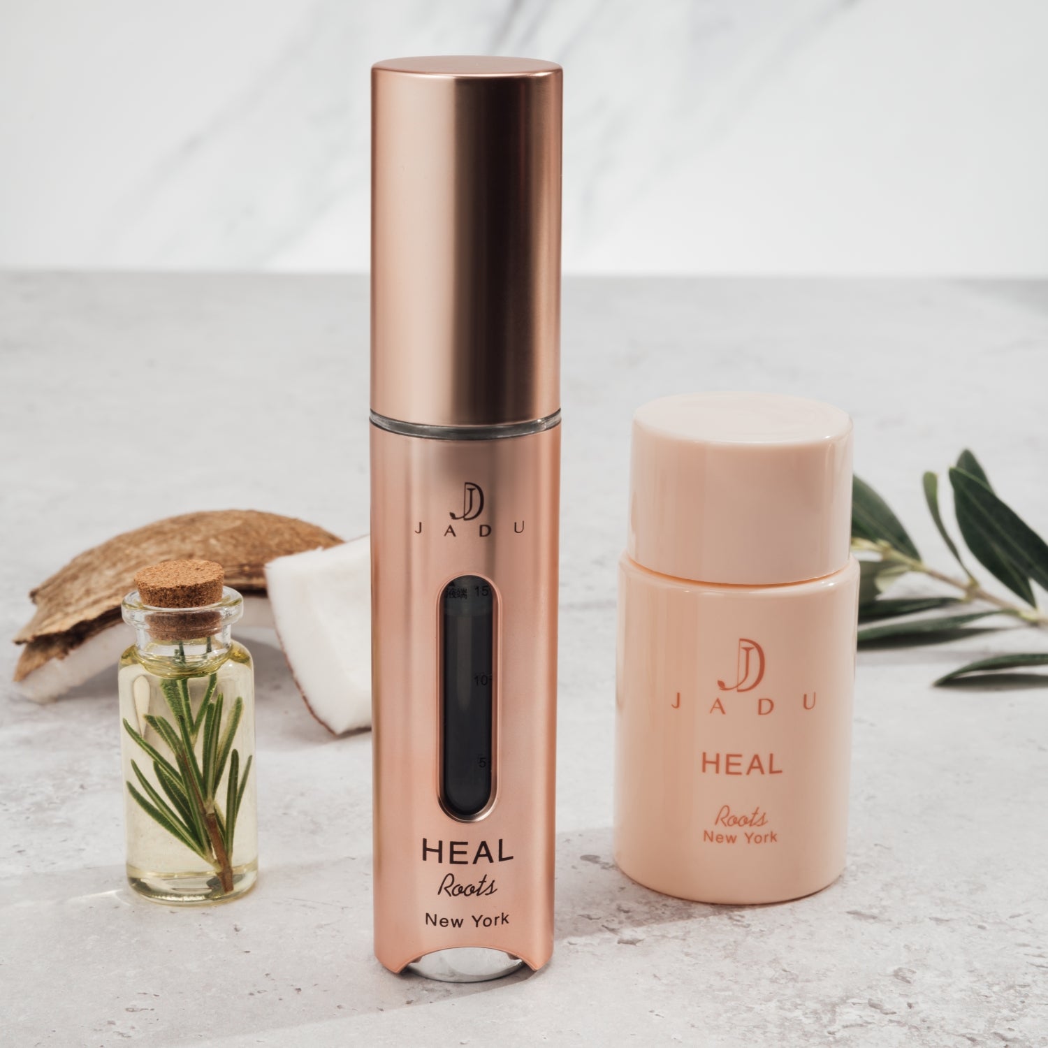 Jadu Heal with rosemary leaf oil and coconut in the background