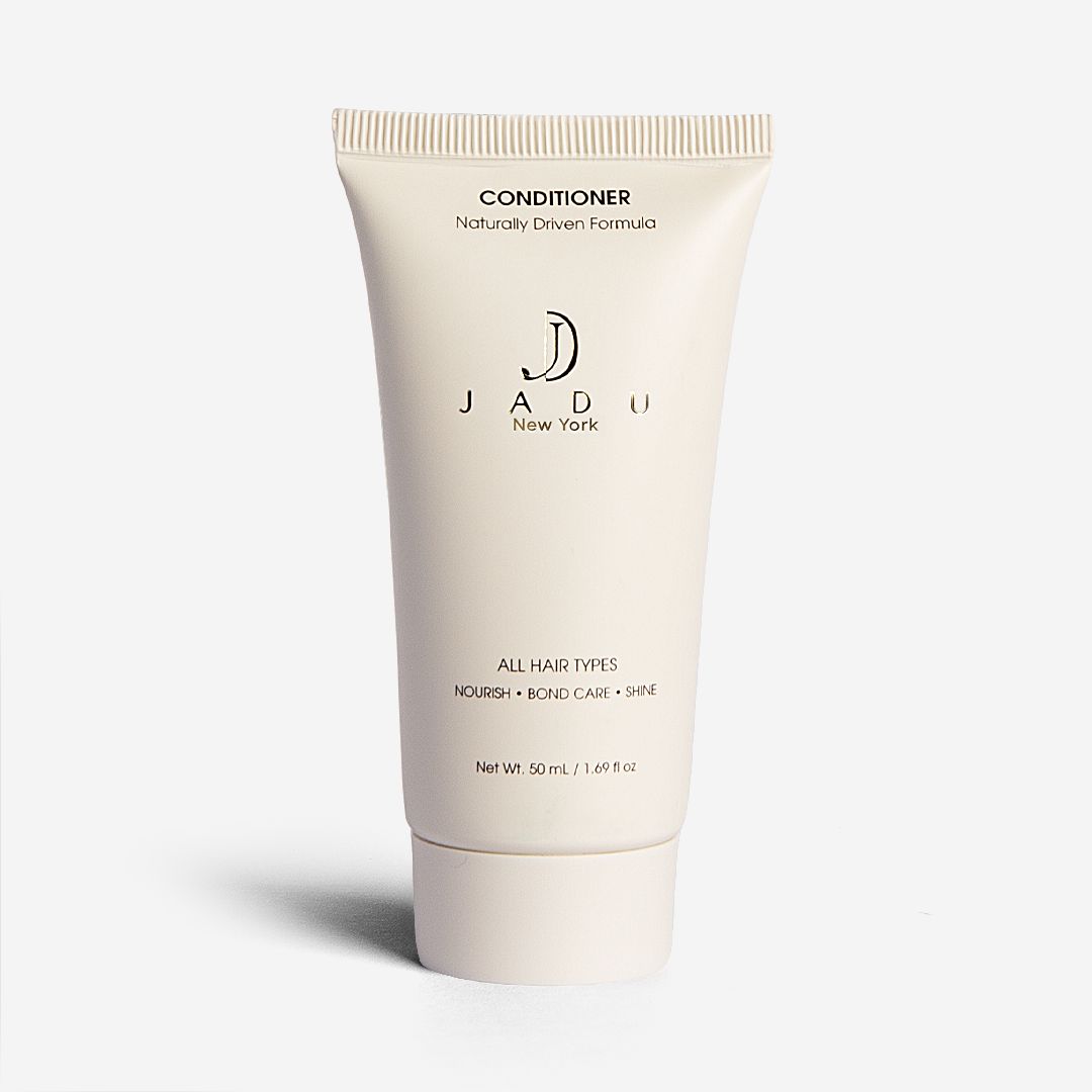 A 50 mL travel-size tube of Jadu Conditioner for all hair types.