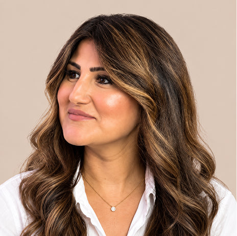 Abigail More, co-owner of Val More Salon, with long, glossy, highlighted waves.