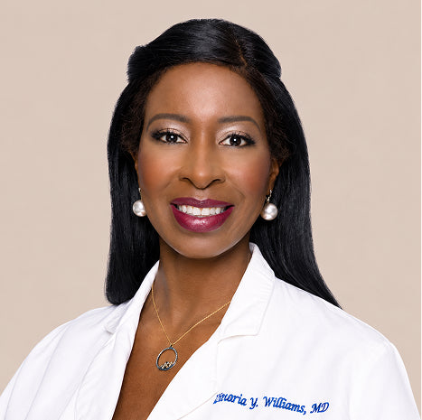 Dr. Zinaria Williams, a hair restoration surgeon, in a white coat.