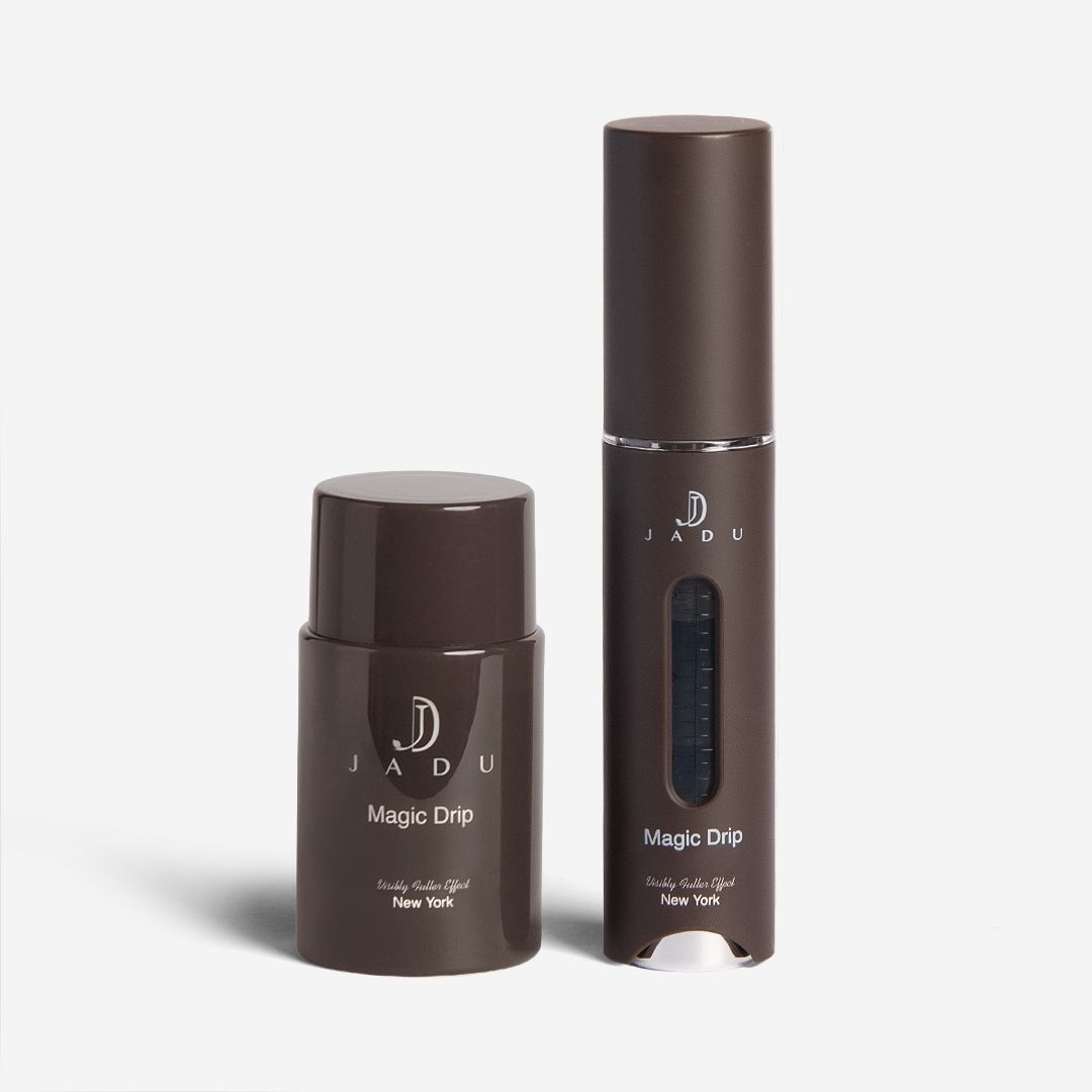 The Jadu Magic Drip bottle shown with its dark brown scalp applicator wand.