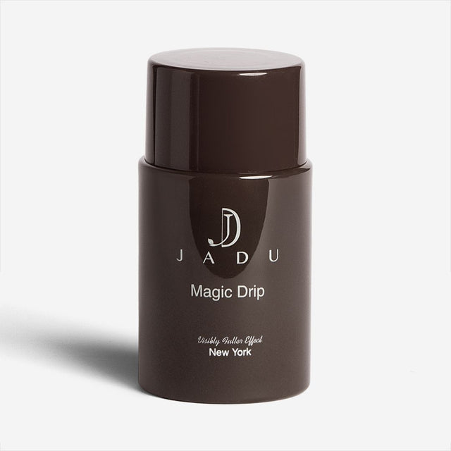 A bottle of Jadu Magic Drip scalp treatment for a visibly fuller effect.