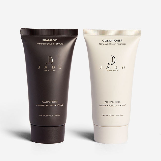 A travel-size duo of Jadu Shampoo and Conditioner tubes, 50 mL each.