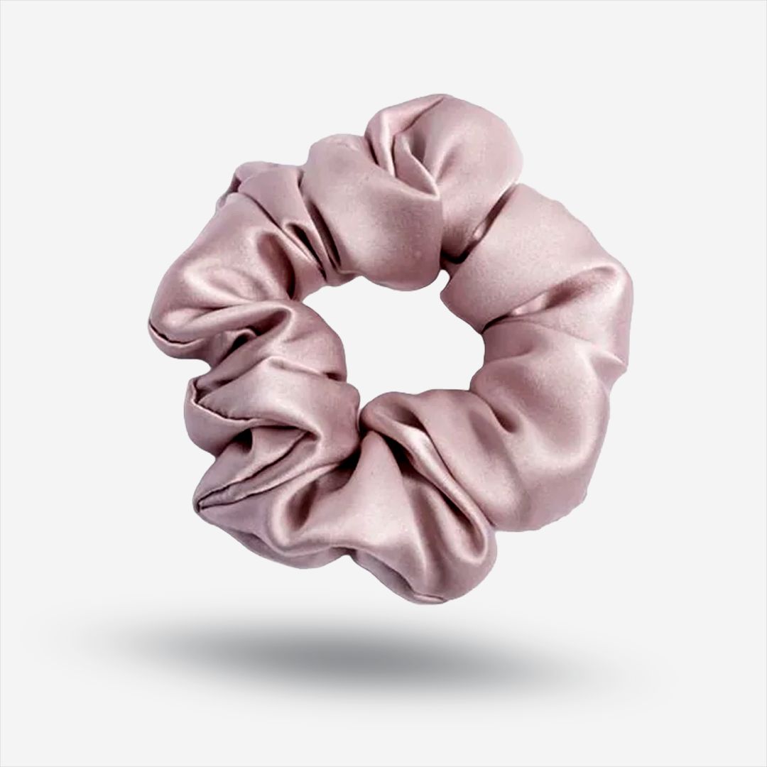 A dusty rose silk scrunchie that is gentle on hair.