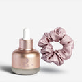 Jadu Split Ends Care hair oil paired with a dusty rose silk scrunchie.